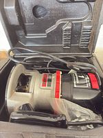 Router and power cord inside open Craftsman case