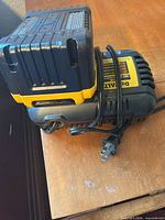 Battery seated on charger showing labels and cord