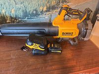 Leaf blower with handle, charger, two batteries visible