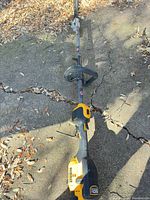 Full length view of DeWalt hedge trimmer on ground