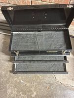 Chest open showing top compartment and three drawers