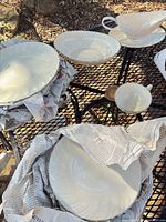 Assorted plates, bowls, cup and gravy boat displayed
