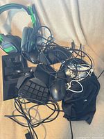 Pile of headset, mice, keypad, dock, cables