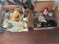 Two boxes containing assorted glassware and ceramic mugs