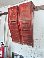 Front view of both red steel ramps hanging on wall
