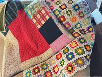 Overview of quilt and afghan lying together showing patterns and colours