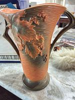 Full view of vase showing color gradient, relief design, handles and base