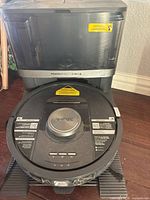 Front view of Shark PowerDetect 2-in-1 robot vacuum on self-emptying dock