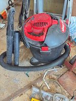 Front view of Shop-Vac with hose and wands attached