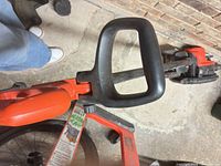 Handle and auxiliary D-loop grip on orange Stihl cordless edger