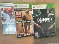 Three Xbox 360 game cases displayed