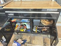 Front view of Yukon rolling cabinet, wood top, doors open showing interior contents