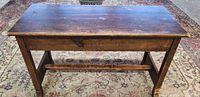 closed antique wooden piano bench on rug