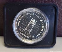 Reverse side of 1977 Canadian $1 Silver Jubilee coin in capsule