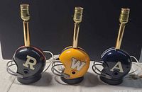 Front view of all three helmet lamps showing team logos