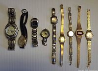 Nine timepieces laid out side by side