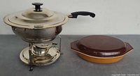 Overall view of chafing dish set beside Pyrex casserole