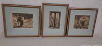 All three framed etchings side by side