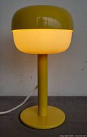 Front view of yellow table lamp illuminated