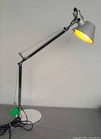 Full side view showing entire lamp, base, adjustable arm and shade