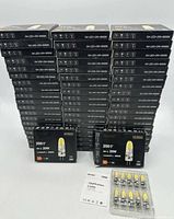 Front view of all stacked Dicuno 10-pack boxes and one open blister showing bulbs