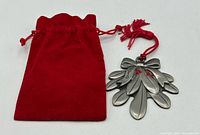 Ornament beside red velvet pouch