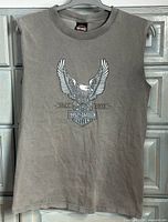 Full view of grey sleeveless tank with eagle and logo graphic