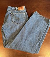 Jeans folded showing back pocket, red tab, leather patch and fabric condition