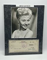 Overall view of matted display showing photo and signed check