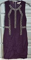 Full front view of purple embellished silk dress on hanger