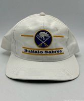 Front view showing embroidered logo and text on brim and crown