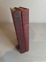 Spine view of both red cloth volumes