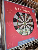 Front of sealed box showing dartboard image and branding