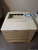 Front view of HP LaserJet 4050TN printer showing control panel and output tray