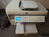 Front and right side view of HP Photosmart Premium C309 printer with control panel and power adapter visible