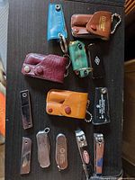 Full lot view of pouches, nail clippers and pocket tools laid out on table