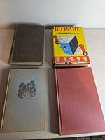 All four books front covers visible