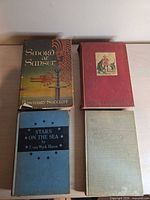 Four books laid flat showing front boards