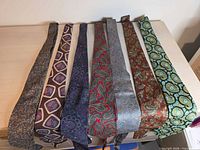 Seven neckties laid flat showing front patterns