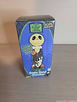 Front view of sealed box showing character image and glow-in-the-dark callout