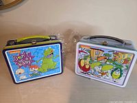 Front view of both sealed Nickelodeon metal lunchboxes