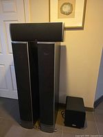 Front view showing pair of RTi12 towers, CSi5 center on top, PSW111 subwoofer on floor