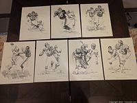 All seven NFL art prints laid out