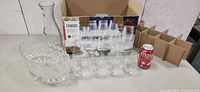 Lot overview showing decanter, fruit bowl, eight of the stemless glasses, Canvas box with remaining glasses