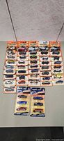 Overall view of 42 sealed Matchbox cars on table