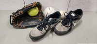 Overall lot with cleats, glove, 2 baseballs, 1 softball