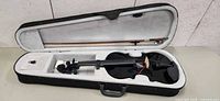 Violin in open case with bow