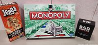 Jenga, Monopoly and Bad People game boxes side by side