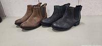 Brown and grey UGG Chelsea boots side by side