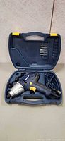Impact driver set in open carrying case showing tool, sockets, bits